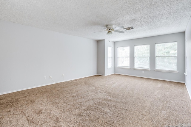 spare room with carpet floors, ceiling fan, and a textured ceiling