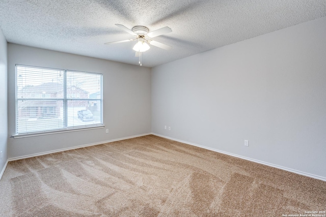 spare room with carpet, ceiling fan, and a textured ceiling