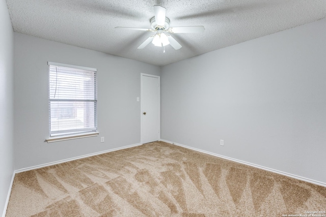 unfurnished room featuring carpet, ceiling fan, and a textured ceiling