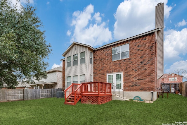 rear view of house with a wooden deck, cooling unit, a yard, and french doors