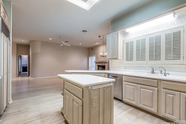 kitchen with dishwasher, pendant lighting, decorative backsplash, a kitchen island, and ceiling fan with notable chandelier