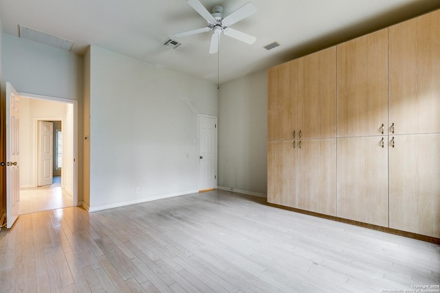 unfurnished bedroom featuring a closet, ceiling fan, and light wood-type flooring