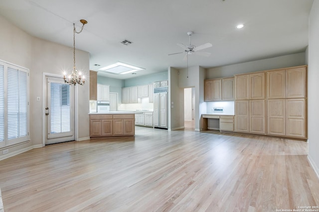 kitchen featuring pendant lighting, light hardwood / wood-style flooring, light brown cabinetry, and paneled refrigerator