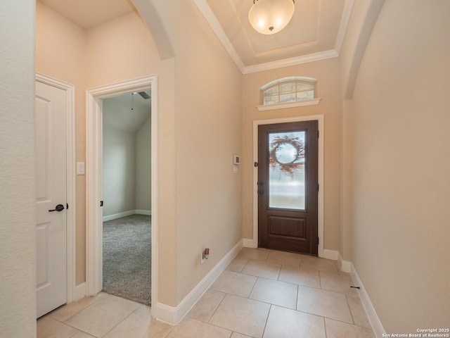 tiled foyer entrance with crown molding