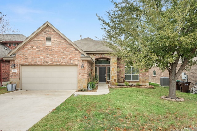 view of front of house with central AC, a garage, and a front yard