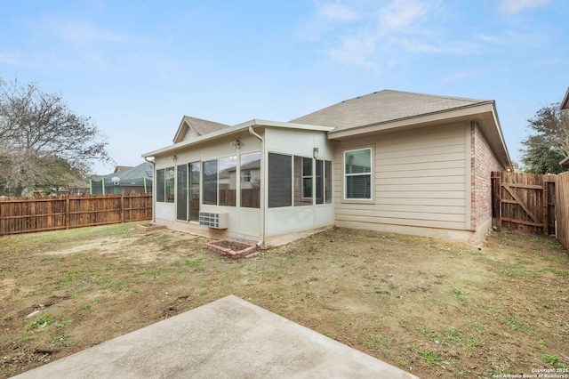 rear view of property with a lawn and a sunroom