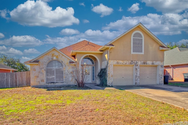 view of front of home featuring a front yard and a garage