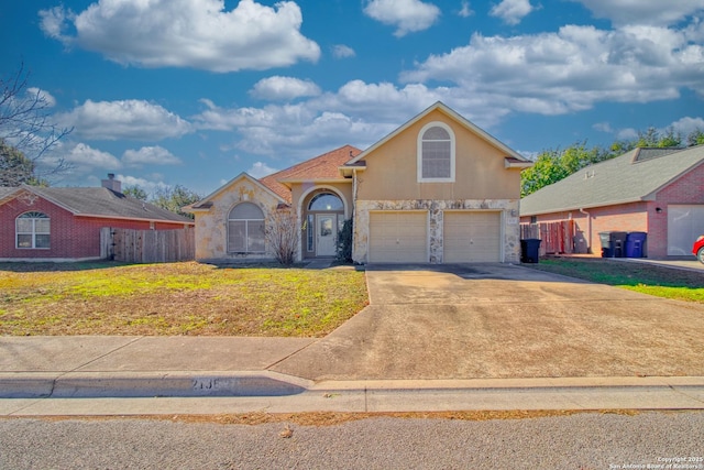 view of front of home with a front yard and a garage