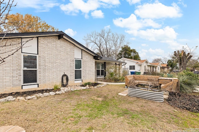 back of property featuring a lawn