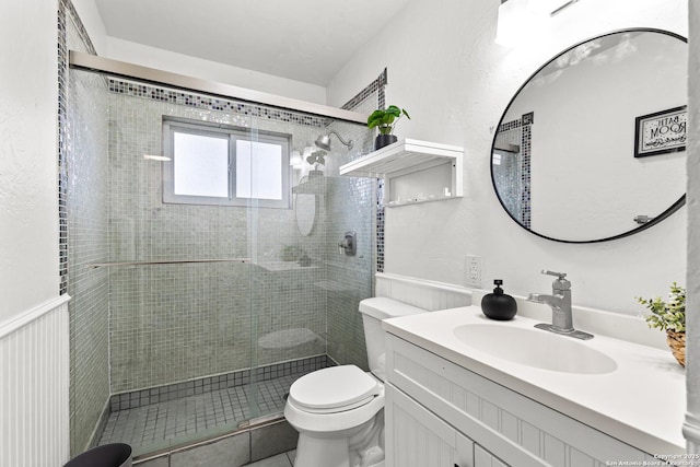 bathroom featuring walk in shower, vanity, and toilet