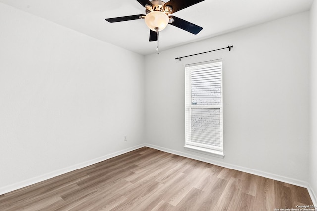 spare room with light hardwood / wood-style floors and ceiling fan