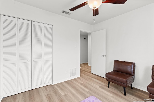 living area with ceiling fan and light wood-type flooring