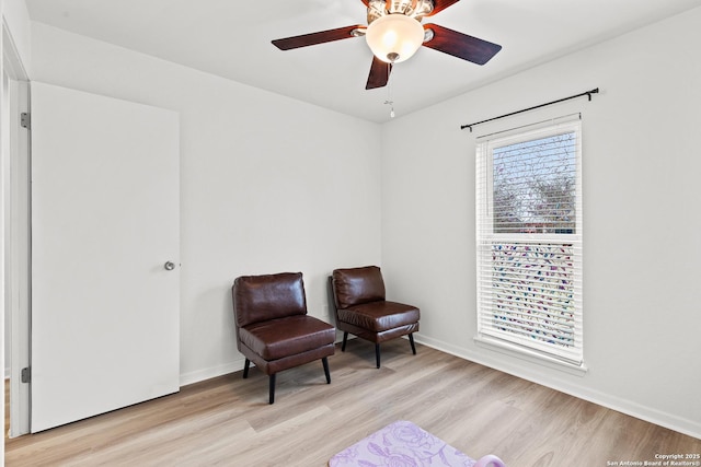 sitting room featuring ceiling fan, light hardwood / wood-style flooring, and a wealth of natural light