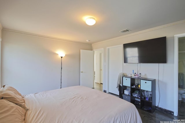 bedroom featuring ensuite bathroom and ornamental molding