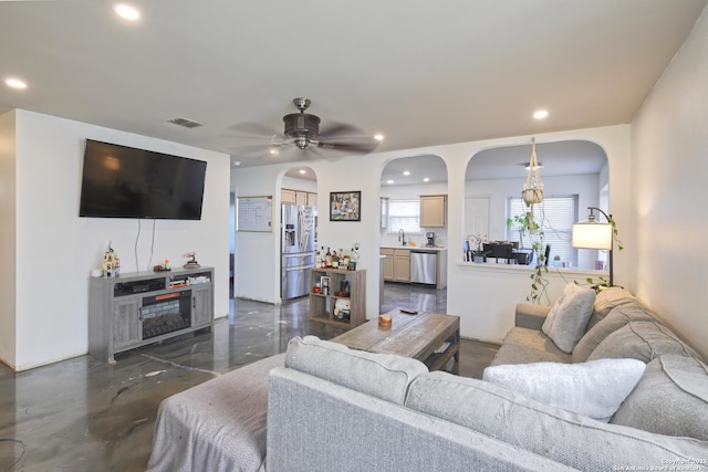 living room with sink and ceiling fan