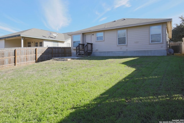 rear view of house featuring a yard