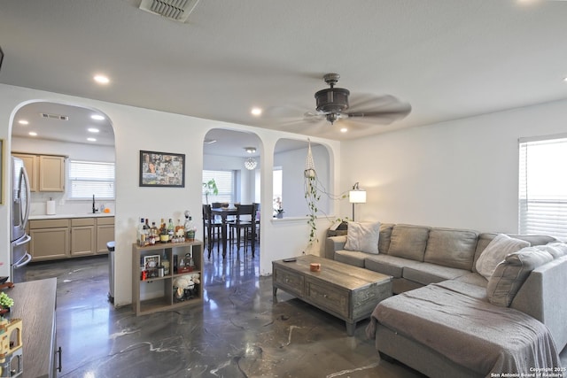 living room with sink and ceiling fan