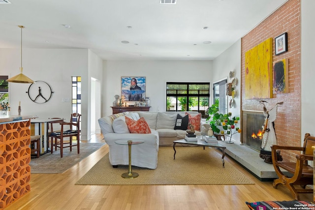 living room featuring a fireplace and light wood-type flooring