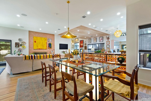 dining area with light hardwood / wood-style floors and plenty of natural light