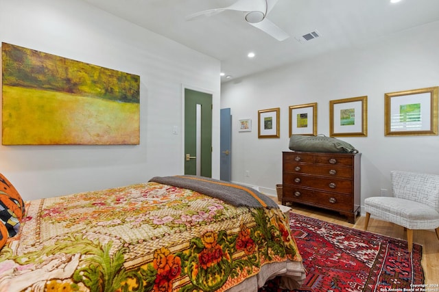 bedroom with ceiling fan and wood-type flooring