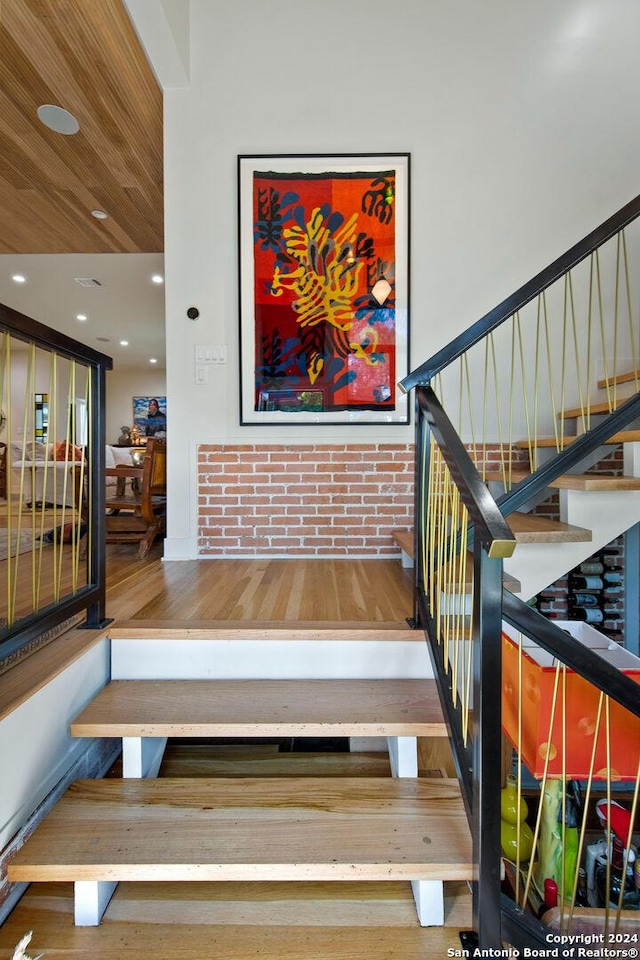 staircase with hardwood / wood-style floors