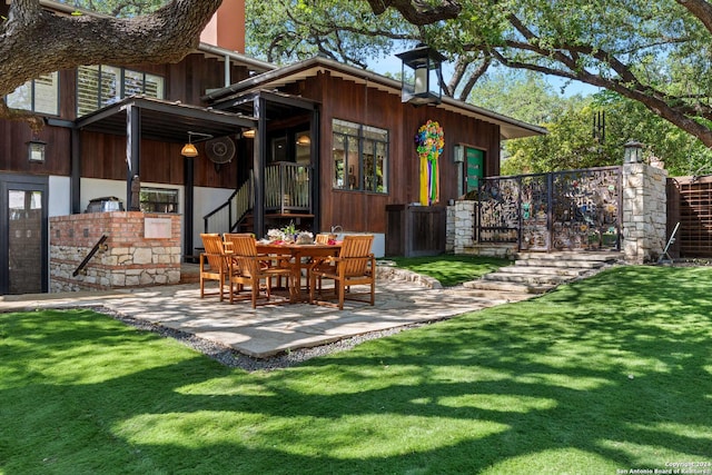 rear view of house with a patio area and a yard