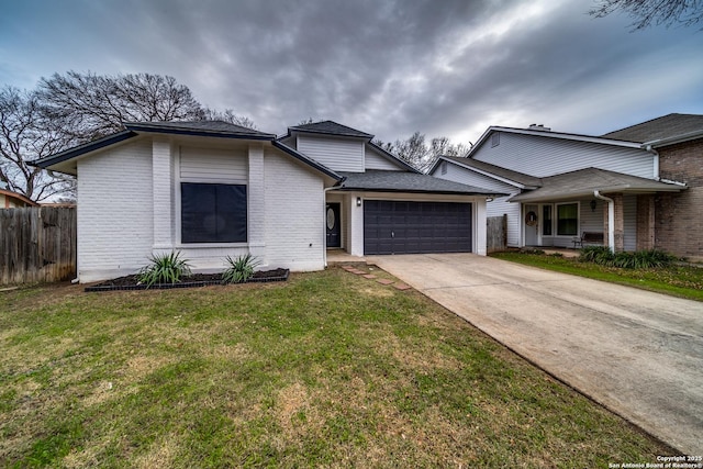 view of front of home with a front yard and a garage