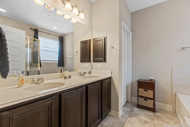 bathroom featuring vanity and shower with separate bathtub