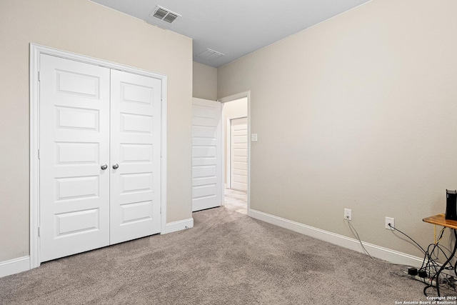 unfurnished bedroom with a closet and carpet