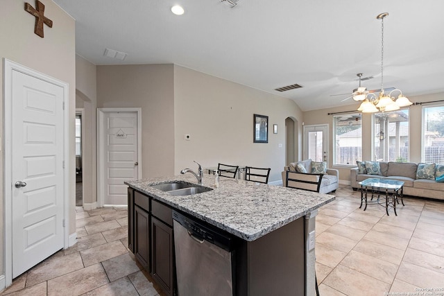 kitchen with stainless steel dishwasher, decorative light fixtures, a kitchen island with sink, ceiling fan with notable chandelier, and sink