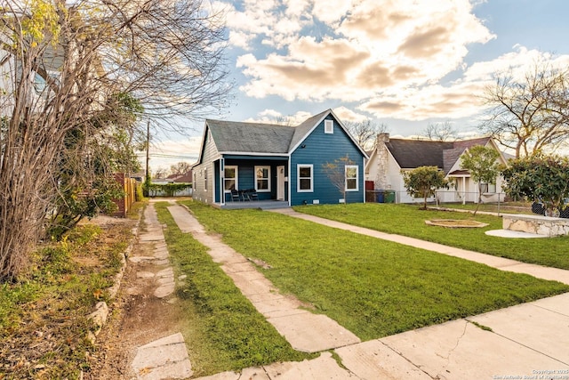 bungalow-style home with central AC and a front lawn