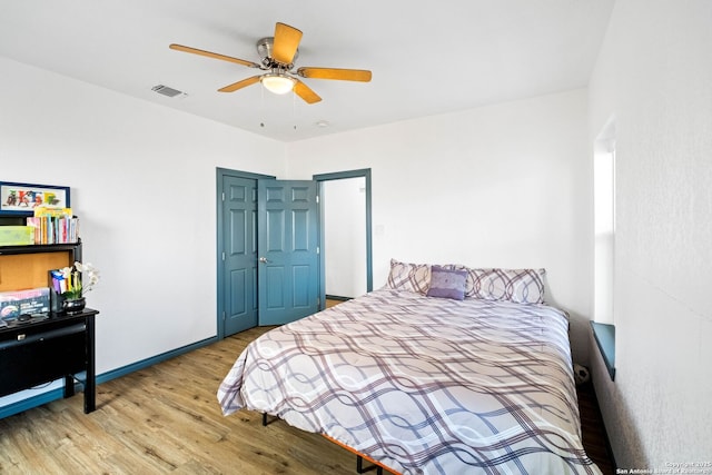 bedroom with ceiling fan and light wood-type flooring