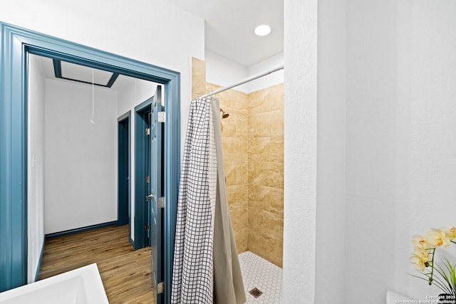 bathroom featuring curtained shower and hardwood / wood-style floors