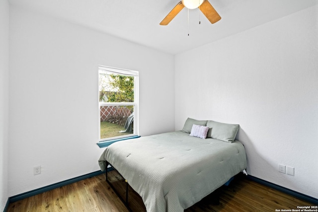 bedroom with ceiling fan and dark wood-type flooring