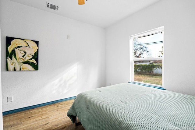 bedroom featuring ceiling fan and hardwood / wood-style flooring