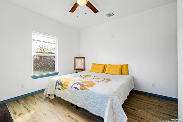 bedroom featuring dark hardwood / wood-style flooring and ceiling fan