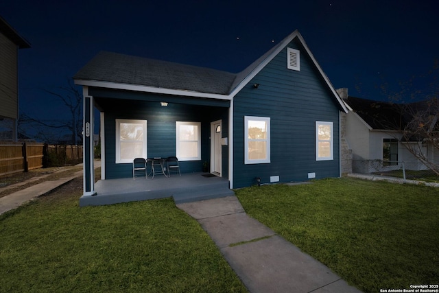 view of front of property featuring a yard and covered porch