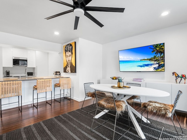 dining room featuring ceiling fan and dark hardwood / wood-style flooring