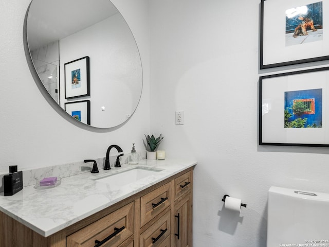 bathroom featuring toilet and vanity