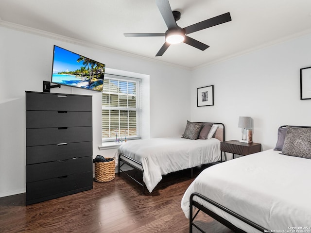 bedroom with dark hardwood / wood-style flooring, ceiling fan, and crown molding