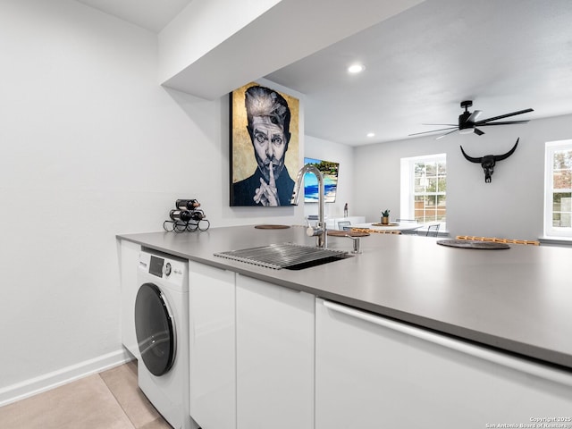 interior space featuring washer / dryer, ceiling fan, light tile patterned flooring, and sink