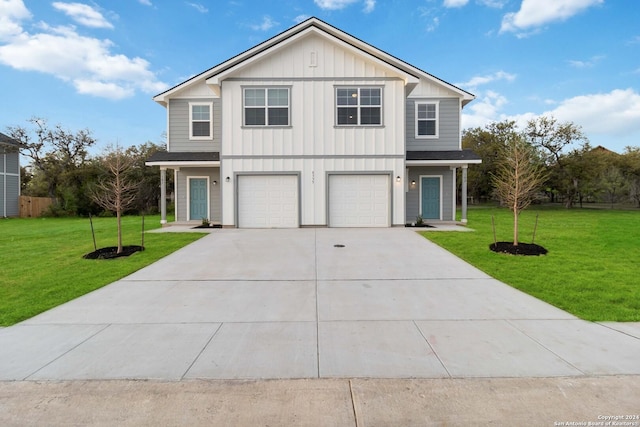 front facade featuring a garage and a front yard