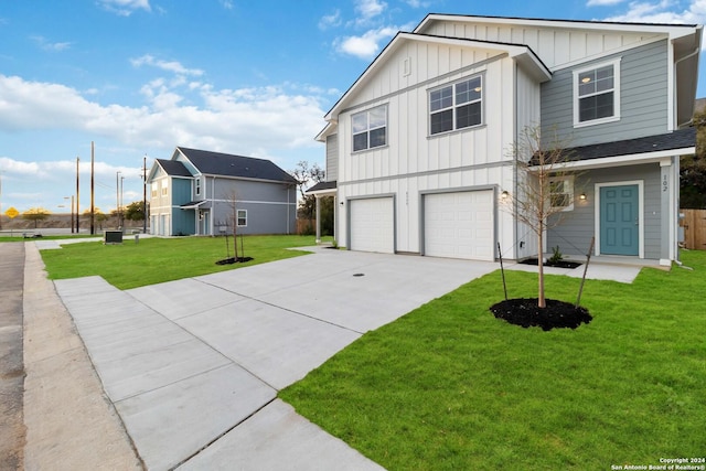 view of front of property featuring a garage and a front lawn