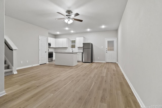 unfurnished living room featuring ceiling fan and light hardwood / wood-style flooring