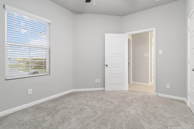 unfurnished room featuring light colored carpet and ceiling fan