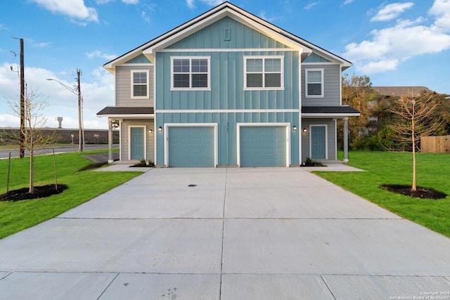 view of front of property featuring a front yard and a garage