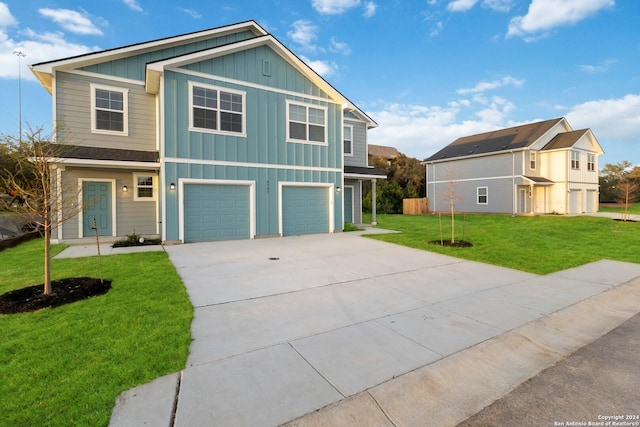 view of front of home with a front yard and a garage