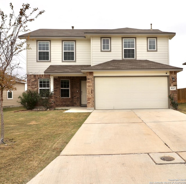 view of front of home featuring a garage and a front lawn