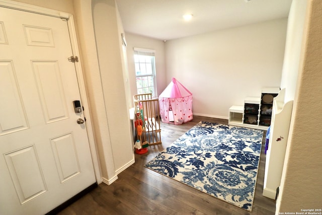 game room with dark hardwood / wood-style floors