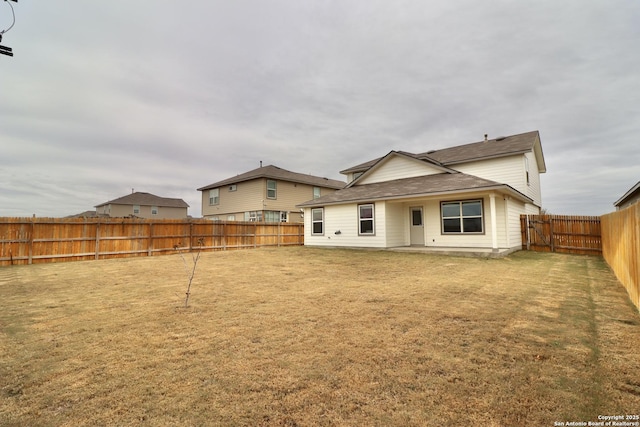 rear view of house with a yard